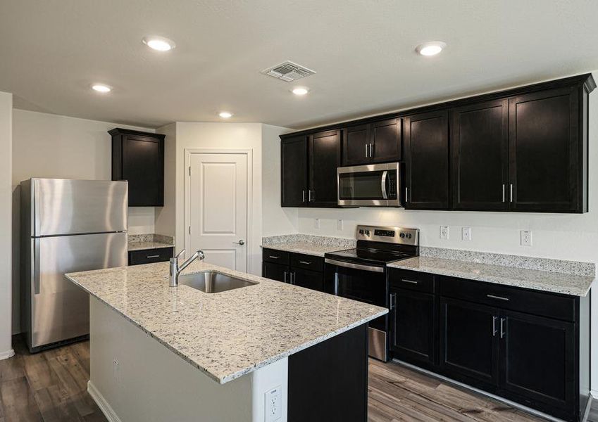 Enjoy stunning granite countertops and designer wood cabinetry in this kitchen.