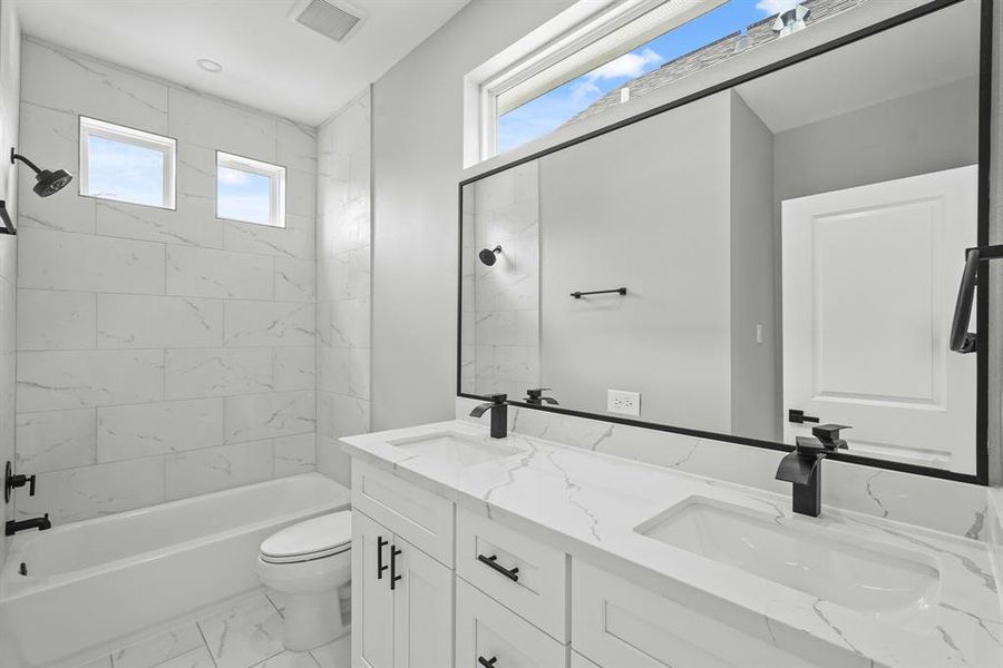 Primary bathroom with double sinks and tub/shower.