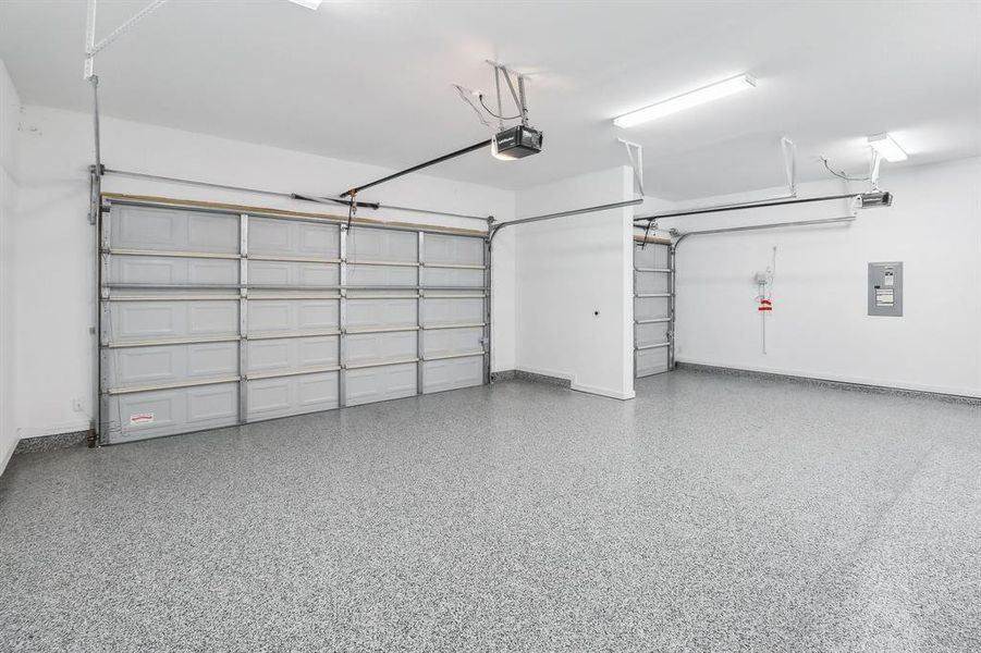 Garage with a garage door opener and Epoxy floors