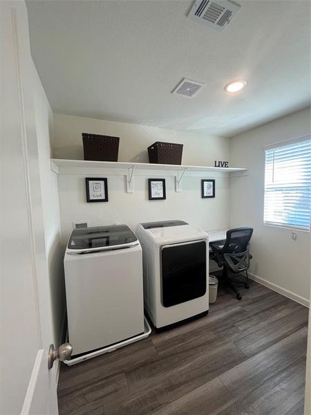 Clothes washing area featuring a textured ceiling, separate washer and dryer, and dark hardwood / wood-style floors