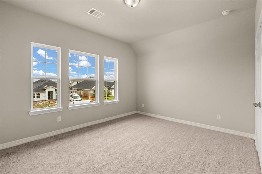 Your secondary bedroom features plush carpet, fresh paint, closet, and a large window that lets in plenty of natural lighting.