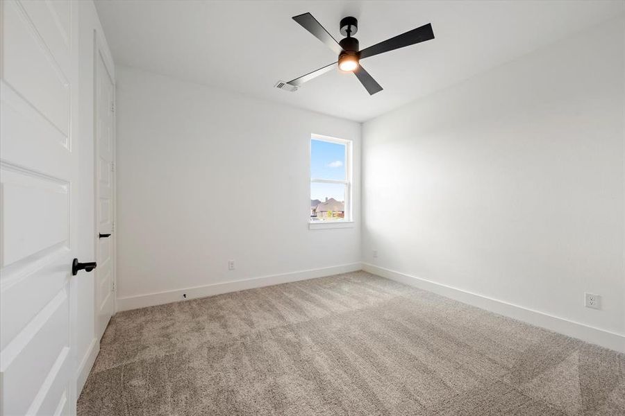 Spare room with carpet floors and ceiling fan