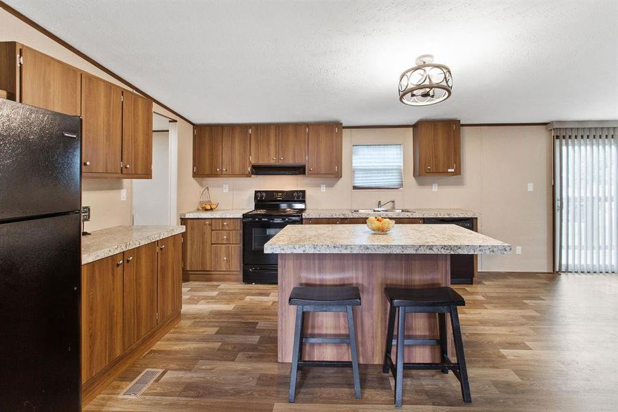 Equipped with appliances such as an electric range, dishwasher, and refrigerator, this kitchen is ready to handle everything from weeknight dinners to holiday feasts.