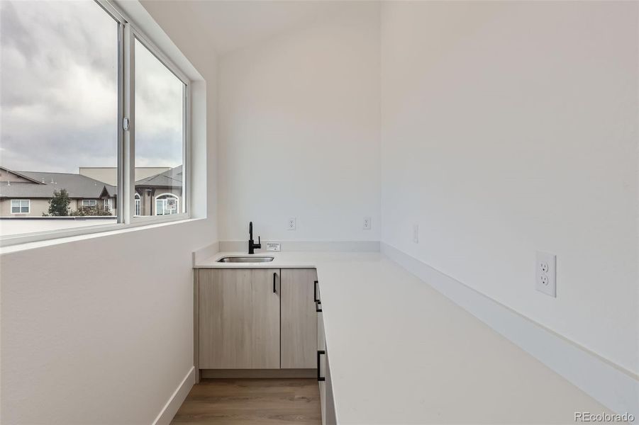 Wet bar on 3rd level with beverage fridge and large sliding window that opens to the rooftop deck for convenient entertaining.