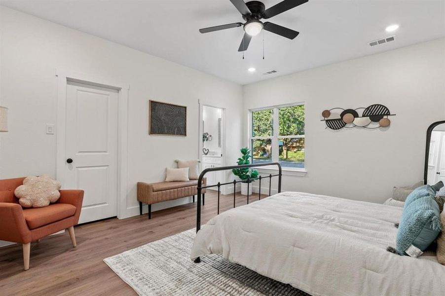 Bedroom with ceiling fan and light wood-type flooring