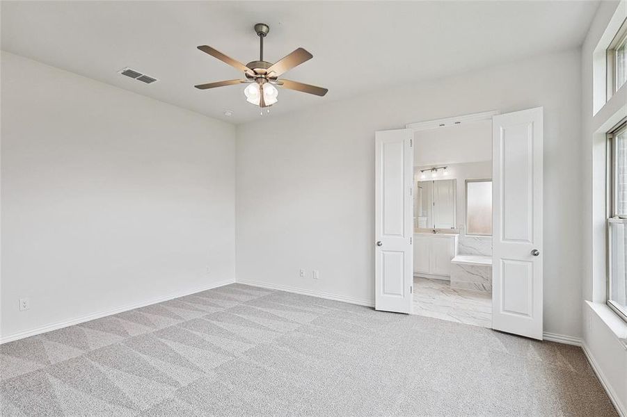 Unfurnished room featuring light carpet and ceiling fan