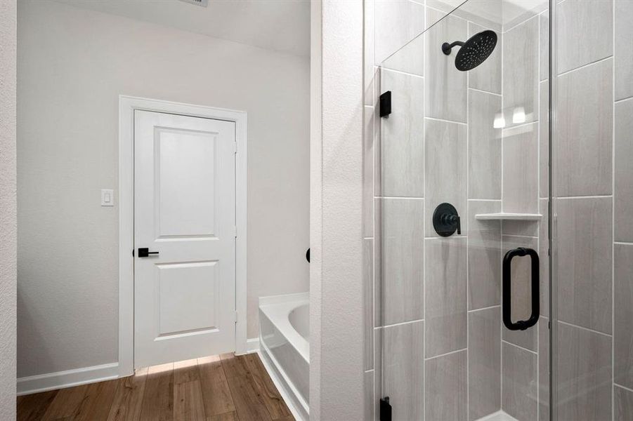 This beautiful shower has the upgraded glass doors, modern black fixtures and a luxurious rainwater showerhead to help make your spa dreams become a reality.