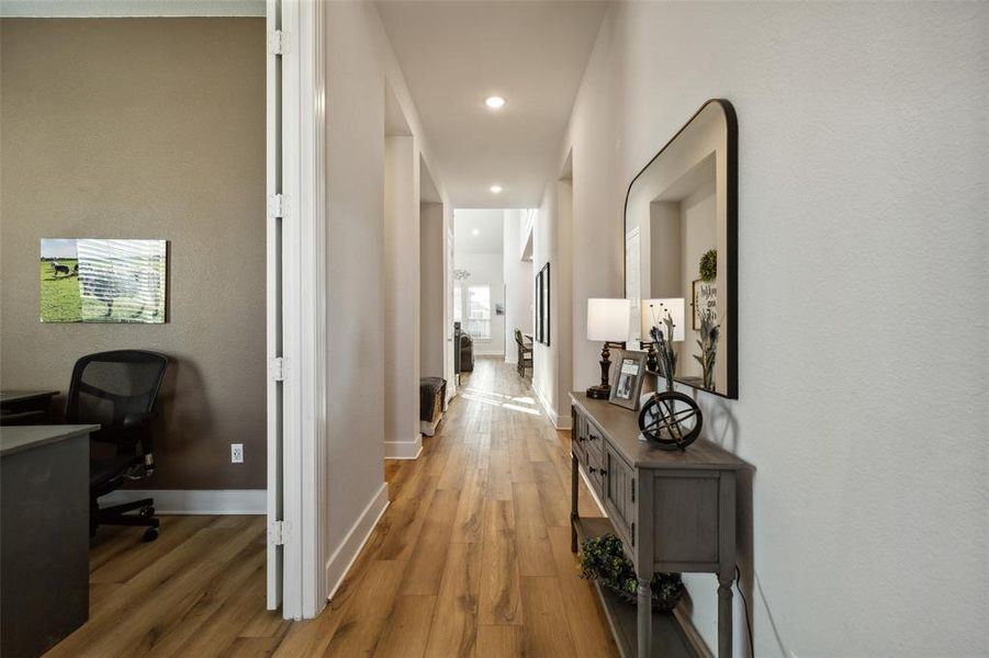 Hallway with hardwood / wood-style floors