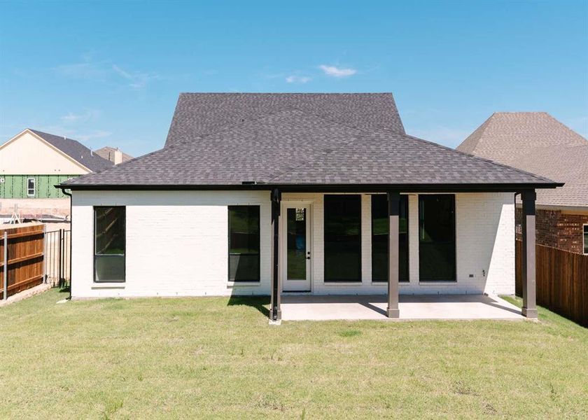 Back of property featuring a patio and a yard