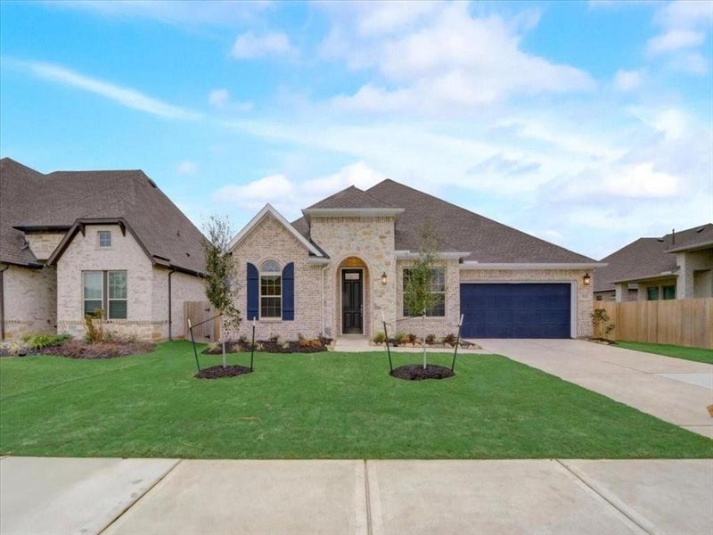 Stunning modern elevation of a David Weekley home, showcasing sleek design and curb appeal.