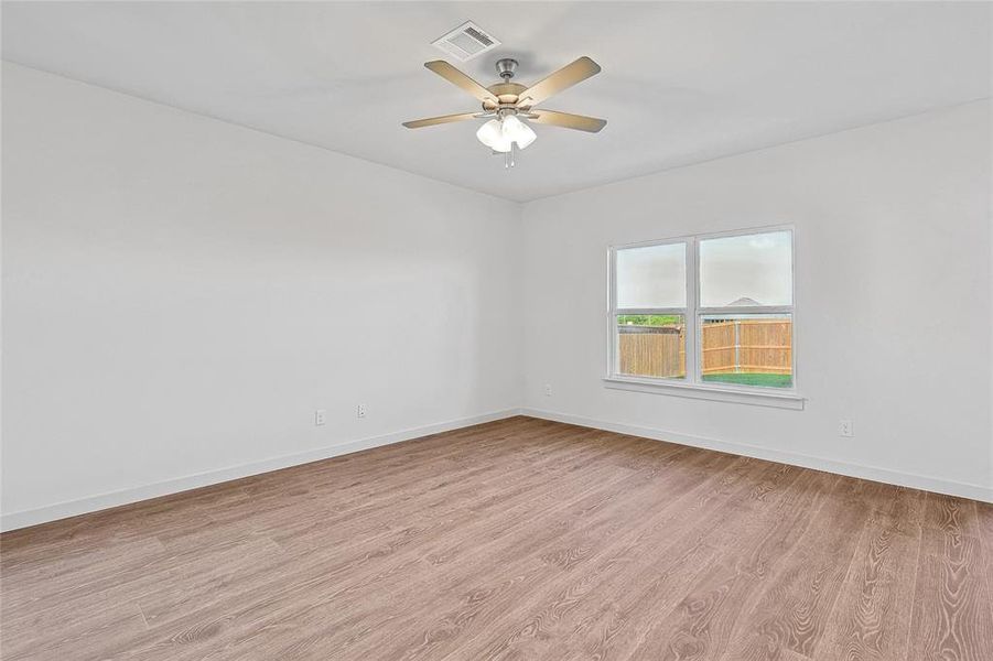 Spare room with light wood-type flooring and ceiling fan