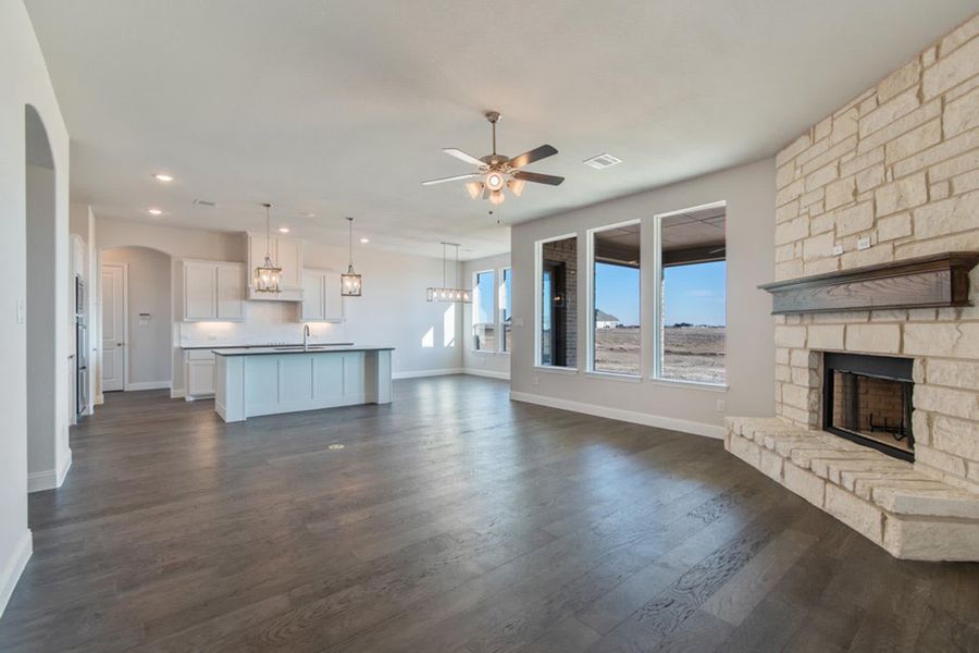 Family Room & Kitchen | Concept 2406 at Hidden Creek Estates in Van Alstyne, TX by Landsea Homes
