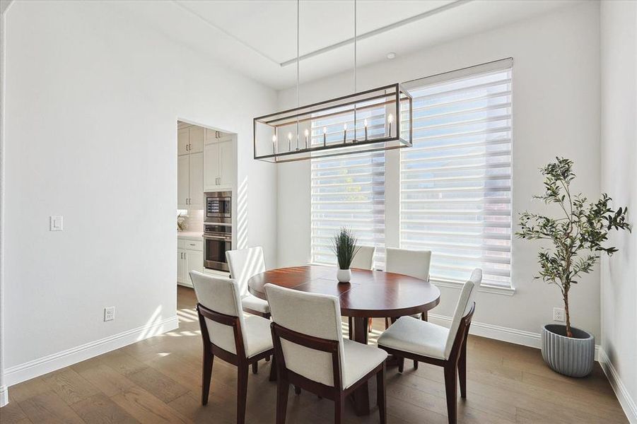 Dining space with hardwood / wood-style floors