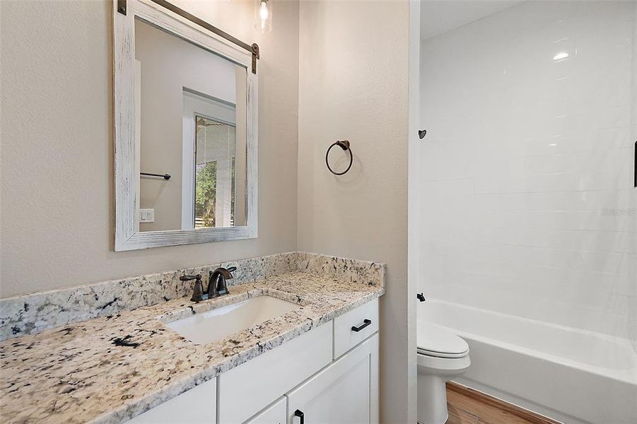 Hall/guest bath with Granite topped vanity - also has a door to the lanai