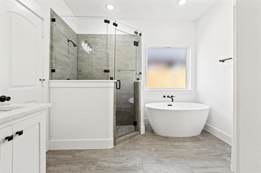 Bathroom featuring independent shower and bath and vanity