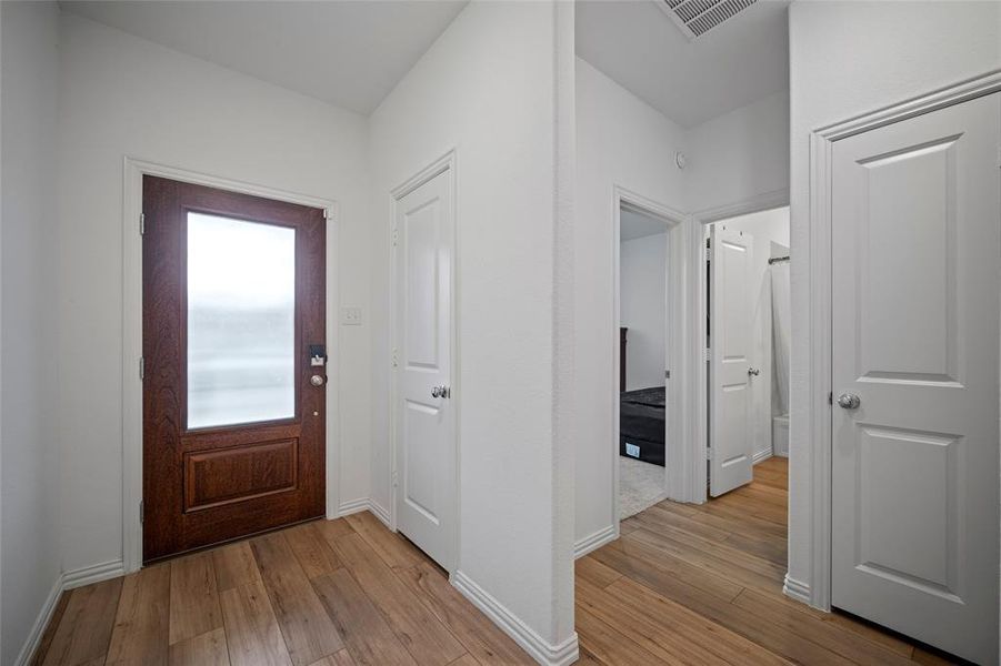 Entrance foyer featuring light wood-type flooring