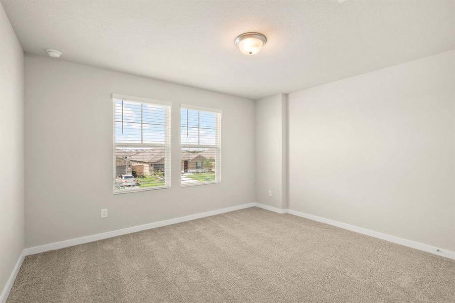 Another view of the Striking Secondary bedroom on second floor featuring plush carpet, oversized windows and double-door closet for added storage.