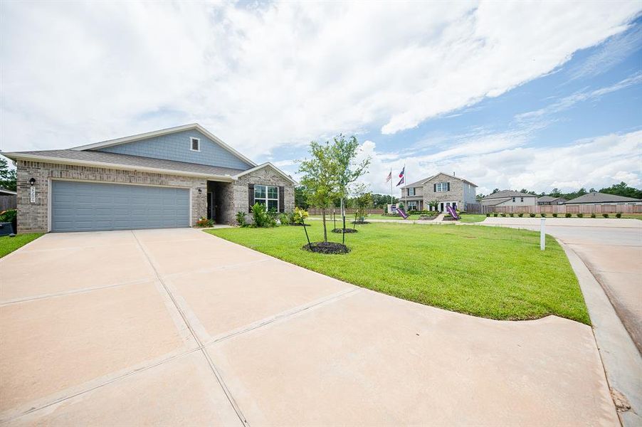 Doublewide driveway leads to 2 car garage.  Sprinkler system keeps the yard green almost all year long!