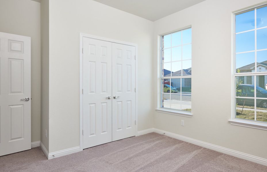 Secondary bedroom with walk-in closet and large wi