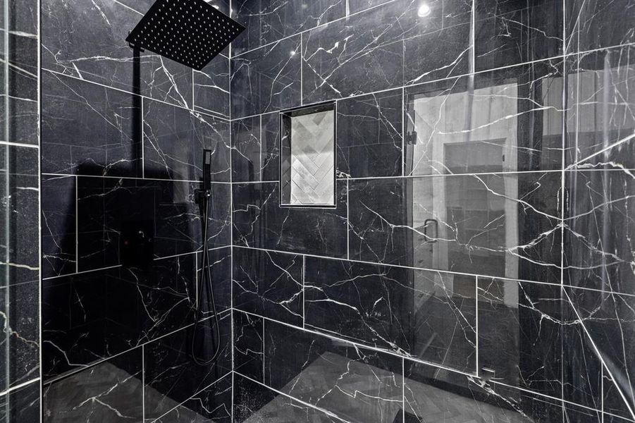 Bathroom featuring a tile shower