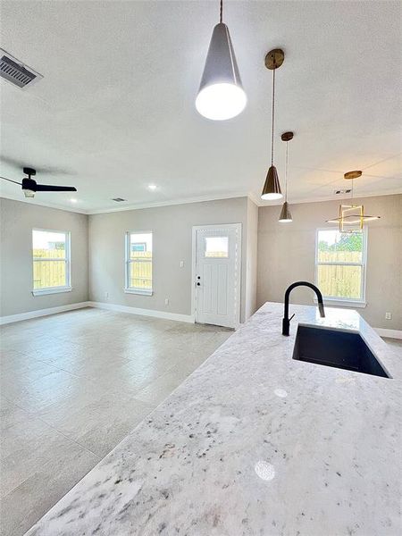 Quartz countertop and gold lighting, wonderful view of the living room