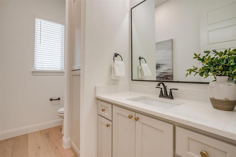 Powder bath featuring built-ins and vanity