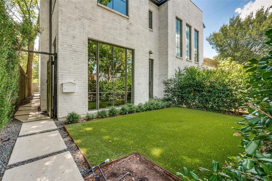 View of side of home with a yard