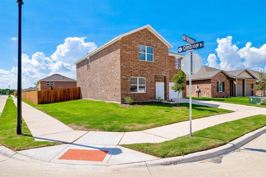 View of front of home featuring a front yard and a garage