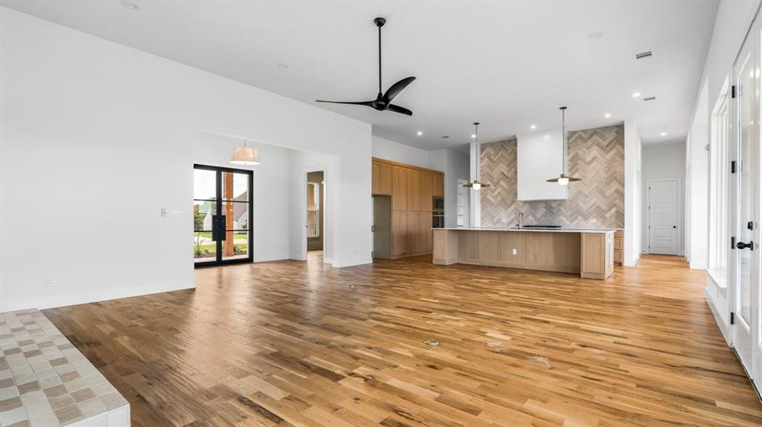 Unfurnished living room with light hardwood / wood-style flooring and ceiling fan