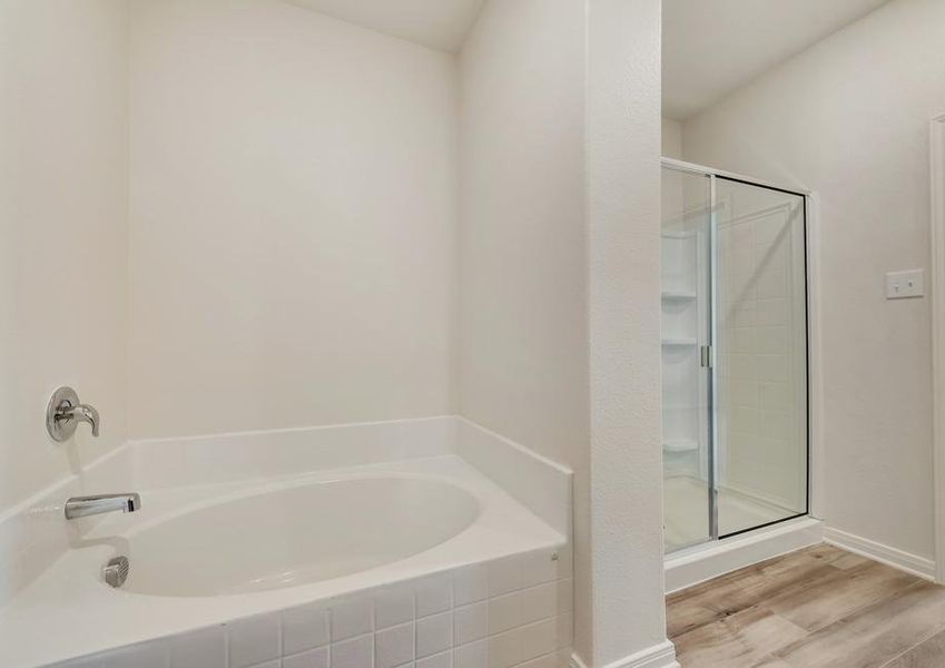 The master bath has a large soaker tub and glass enclosed shower.