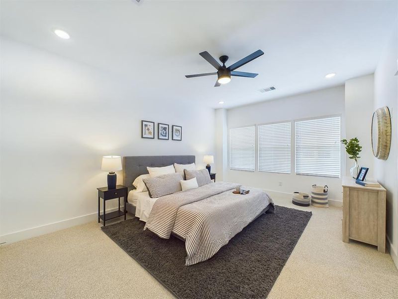 Very spacious primary bedroom located on the 2nd floor. The high ceilings, with recessed lighting, are prewired and blocked for ceiling fans (not included).