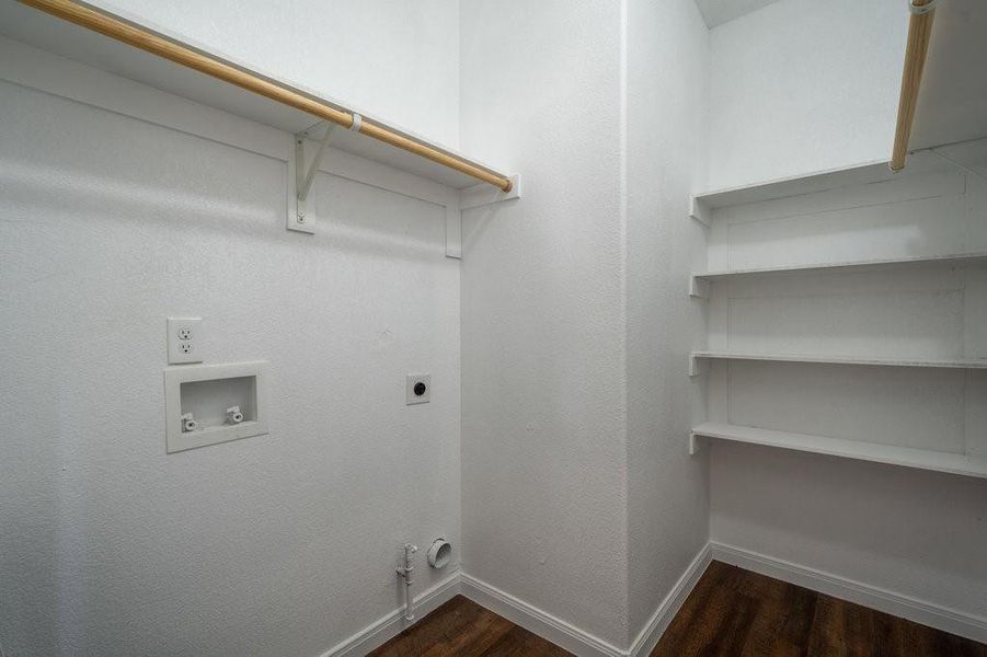 Separate laundry area with extra storage space.