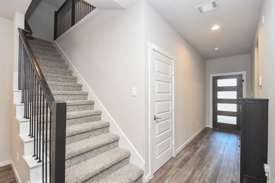 Entryway with a view of the staircase leading upstairs.