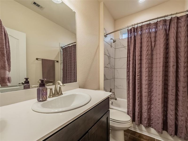 secondary bathroom between the 2 secondary bedrooms has you granite counter tops, tub shower combo and the small window to allow natural light in