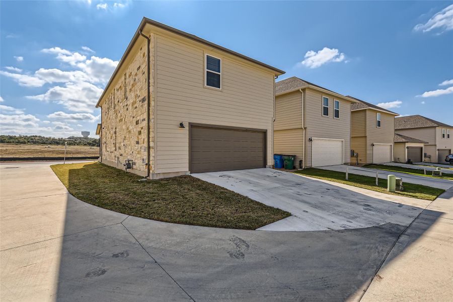 This home provides an alley access two car garage along with a driveway with space for parking.