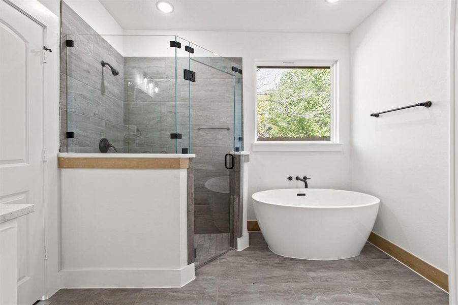 Bathroom featuring shower with separate bathtub