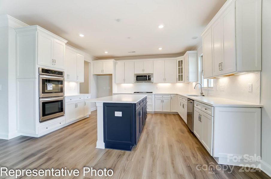 Kitchen will have white cabinets with Gray Island