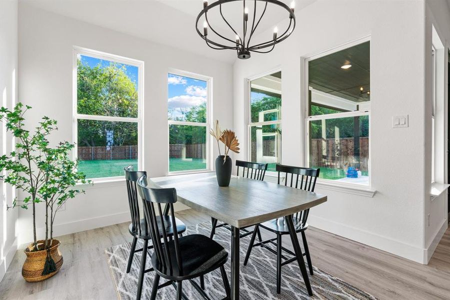 Dining area featuring wood-type flooring and a notable chandelier