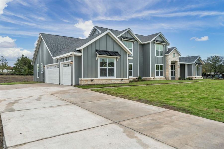 View of front of home featuring a front yard and a garage