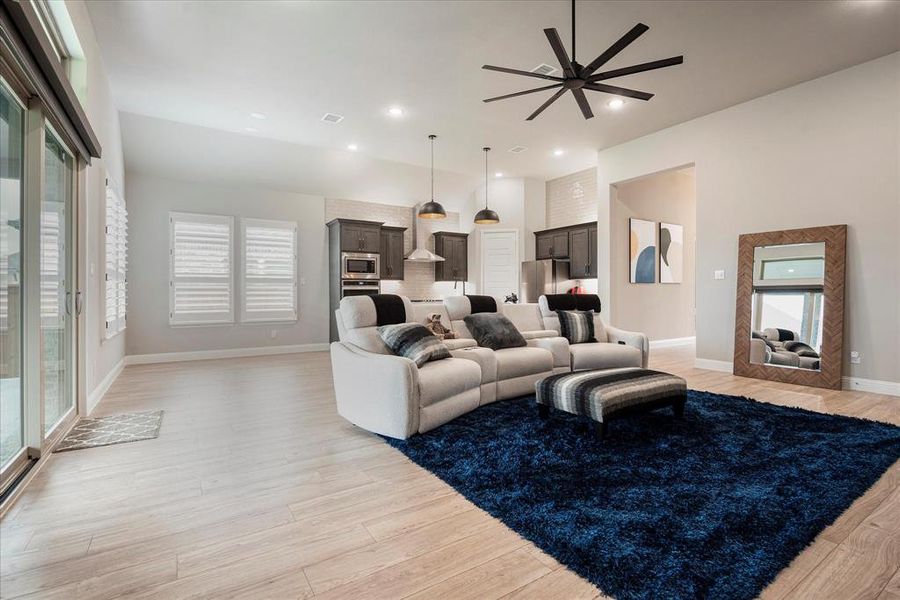 Living room featuring light hardwood / wood-style flooring and ceiling fan