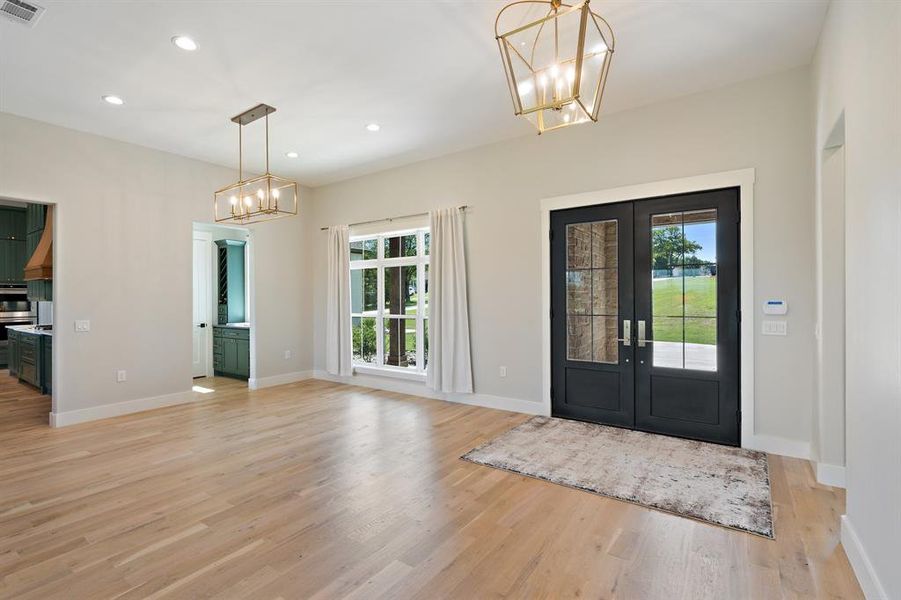 Entryway with a healthy amount of sunlight, light hardwood / wood-style flooring, and french doors