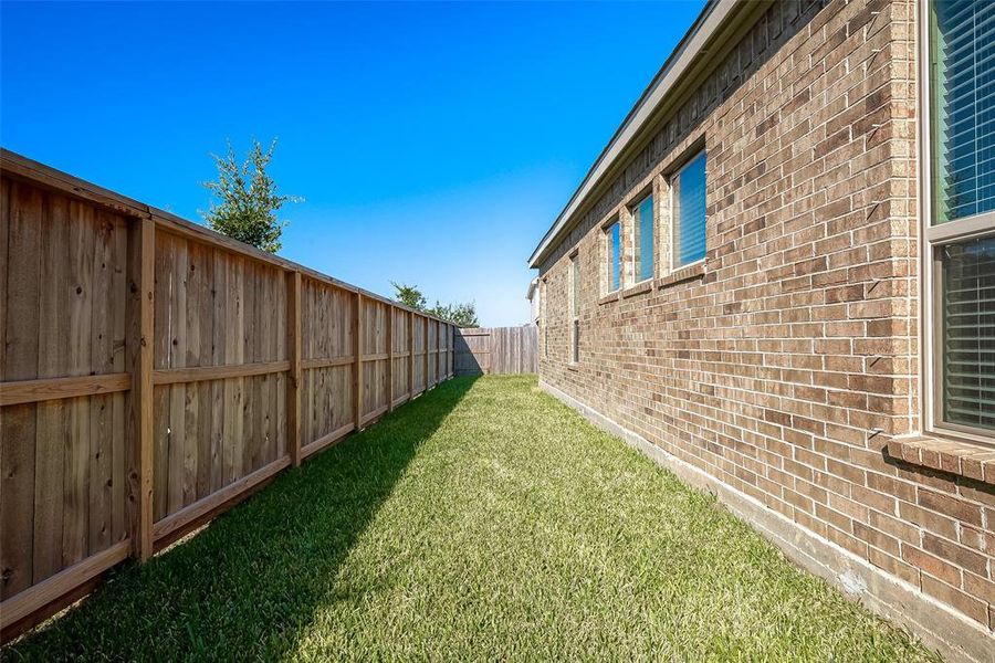 The side yard is perfect for a dog run.