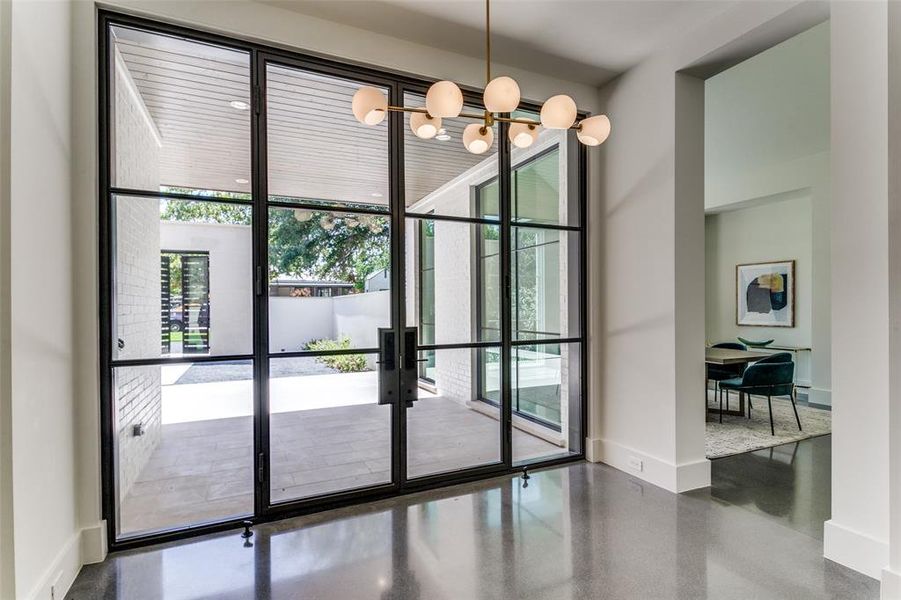 Doorway to outside with french doors and a chandelier