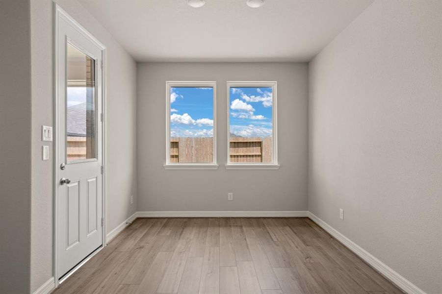 With an abundance of natural light streaming through the windows, the breakfast nook is bathed in a sunny glow, creating the perfect atmosphere to enjoy your morning coffee or a family breakfast.