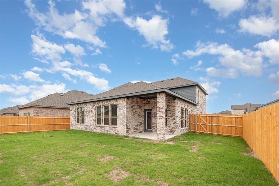 Back of property with a patio area and a yard