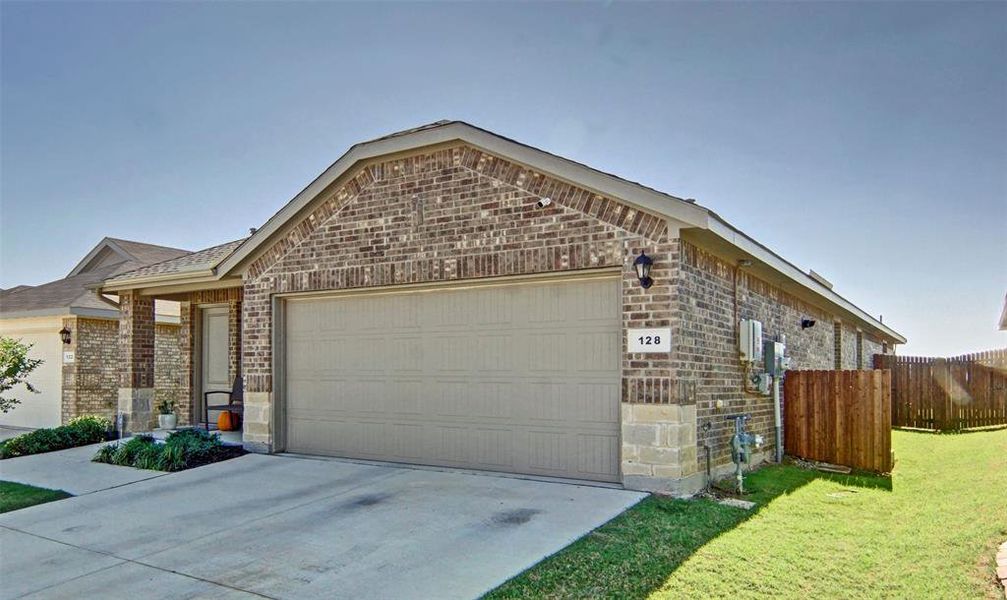 View of front of property with a front lawn and a garage