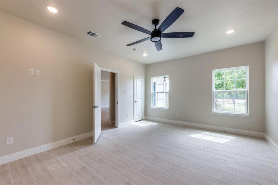 Unfurnished bedroom with ceiling fan and light hardwood / wood-style flooring