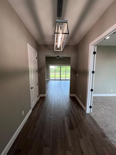 Corridor featuring dark wood-type flooring