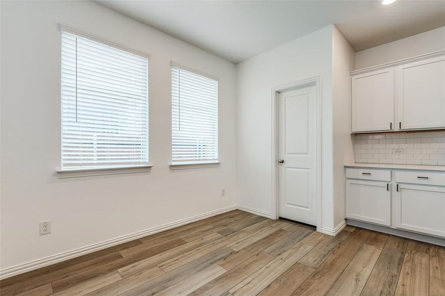 Unfurnished dining area with light hardwood / wood-style flooring