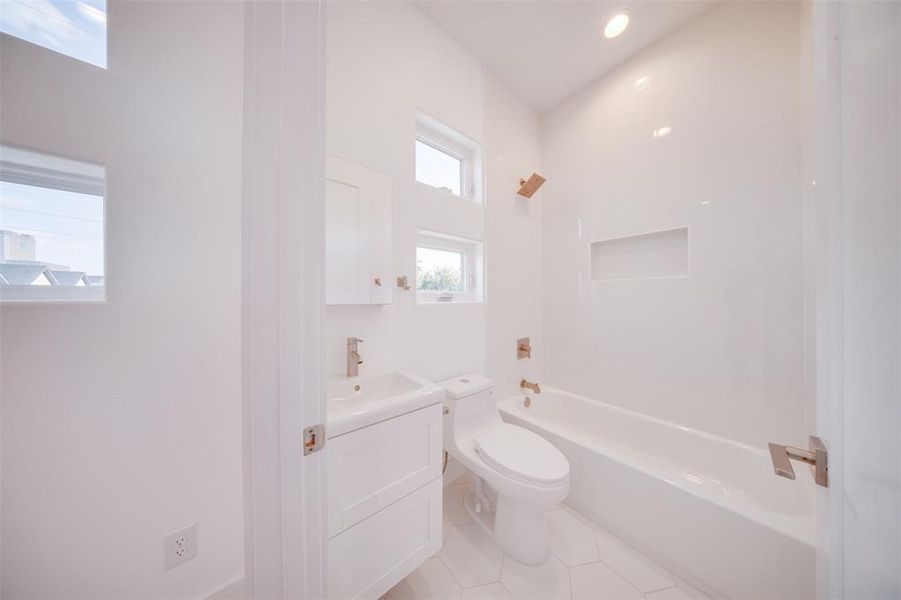 Full bathroom featuring vanity, tile patterned floors, toilet, and shower / bathtub combination